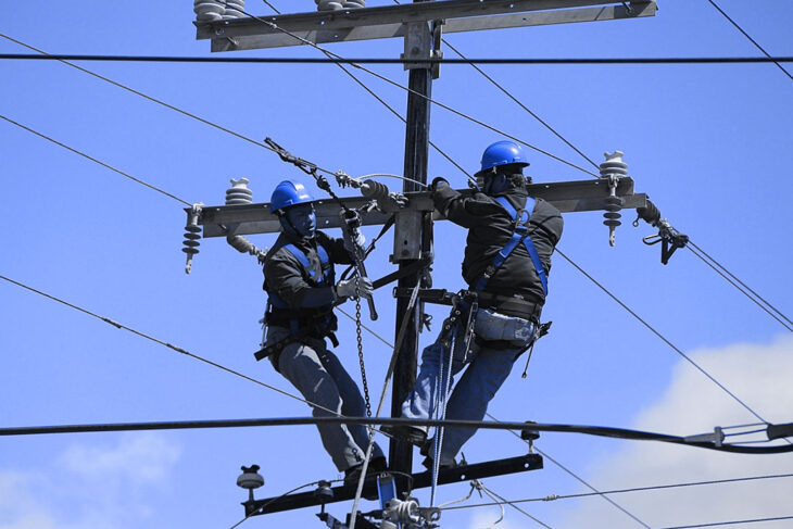 Workers fixing a telephone wire